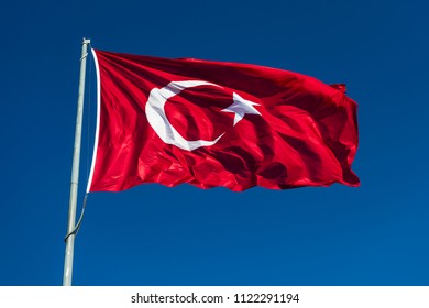 Turkish Flag Waving In Blue Sky.