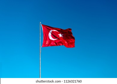 Turkish Flag Waving In Blue Sky.