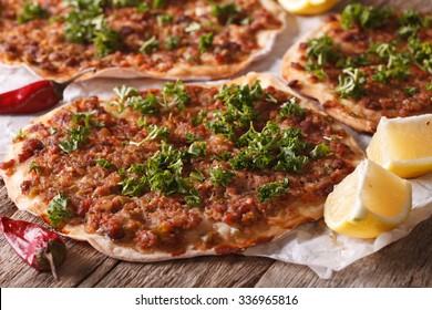 Turkish Food: lahmacun closeup on a wooden table. Horizontal