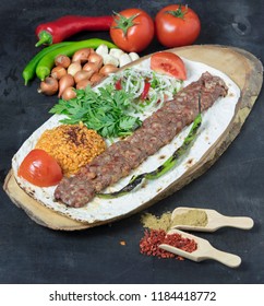 turkish kebab adana with vegetables on the plate - Shutterstock ID 1184418772