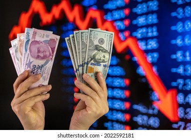 Turkish Lira and US Dollar Exchange. Stock market crash screen representation in the background.