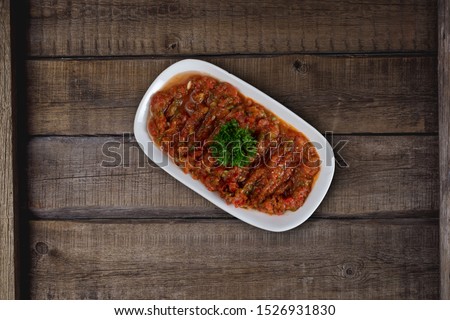 Turkish meze, acili ezme or spicy paste with bread isolated on wooden background Stok fotoğraf © 