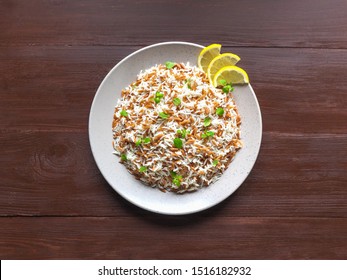 Turkish Rice Pilaf With Orzo In A Plate On A Brown Wooden Background. Top View.