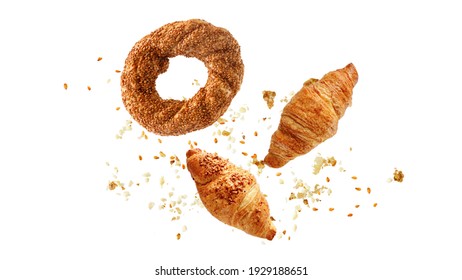 Turkish simit sesame bagel, french butter and almond nut croissants flying with crumbs isolated on white background.  - Shutterstock ID 1929188651