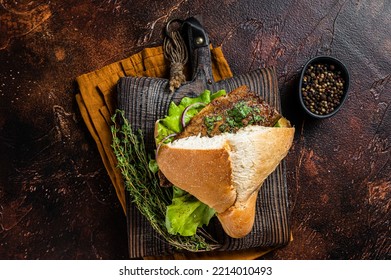 Turkish Street Food Balik Ekmek, Fish Sandwich With Grilled Mackerel Fillet In A Bun. Dark Background. Top View.