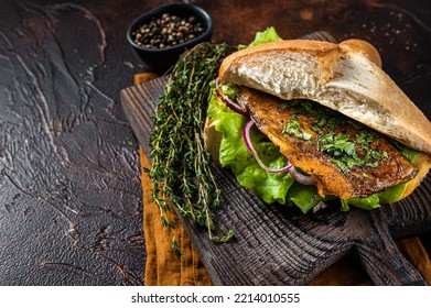 Turkish Street Food Balik Ekmek, Fish Sandwich With Grilled Mackerel Fillet In A Bun. Dark Background. Top View. Copy Space.