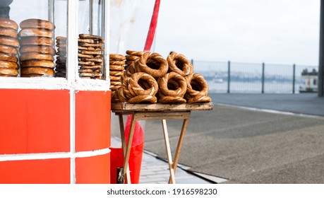 Turkish Street Food. Red Cart On The Street Of Istanbul With Bagels Simit. 