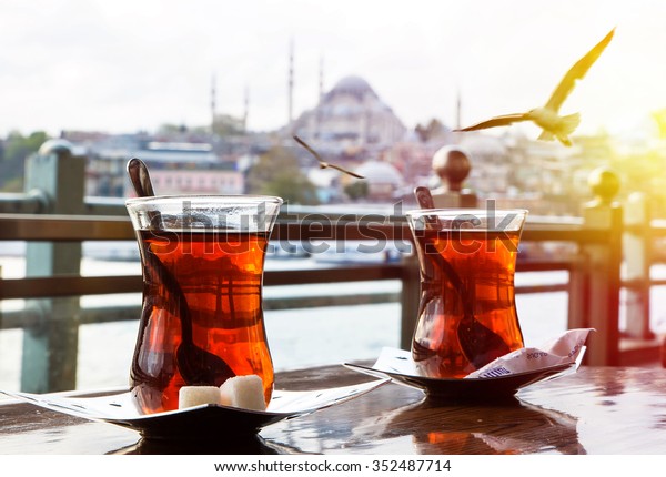 Turkish tea\
cup on the background of port in\
Istanbul