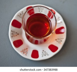 Turkish Tea In Traditional Glass On A Gray Background. Close Up. Top View