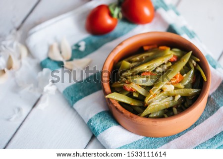Turkish traditional Fresh Beans food casserole in bowl. Green beans olive oil whiteboard on the floor