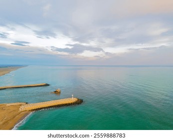 Turkiye Sakarya Karasu Adapazari Aerial view of a tranquil coastal harbor with breakwaters and a small vessel.High-angle, full shot of a serene coastal harbor, showcasing a calm turquoise sea meeting  - Powered by Shutterstock