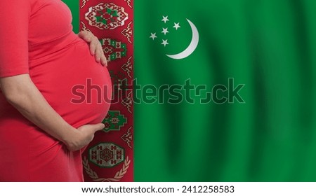 Turkmen pregnant woman belly on flag of Turkmenistan background