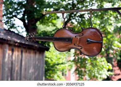 TURKU, ABO FINLAND ON JUNE 30. View, closeup of a wooden violin, fiddle above a street. Sign, a symbol for a luthier on June 30, 2013 in Old Town, Turku, Abo Finland.
