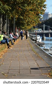 TURKU, FINLAND September 25, 2022 - People Are Enjoying A Sunny And Warm Autumn Day On A River Bank In The City Center.