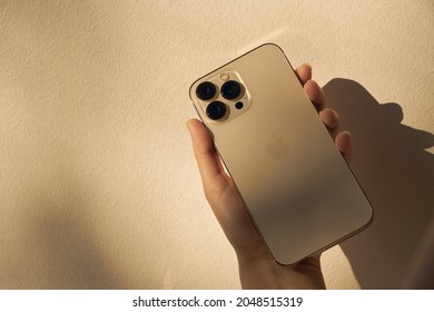 Turku, Finland - September 26, 2021: New iPhone 13 pro max in gold in a hand