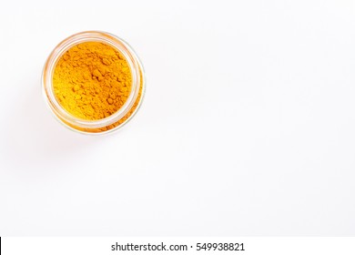 Turmeric In Glass Jar. Isolated On White. Empty Space For Text Or Inscription. Top View.