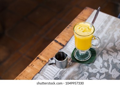 Turmeric Golden Latte On Coconut Milk At The Restaurant. Vegan Raw Food Concept. Drink Photography