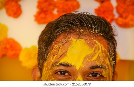 Turmeric paste applied on forehead of a man.image from a Haldi ceremony in India