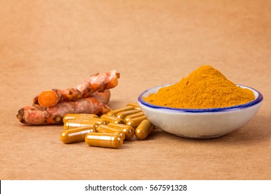 The Turmeric Powder , Capsule And Roots Curcumin On Wooden Plate