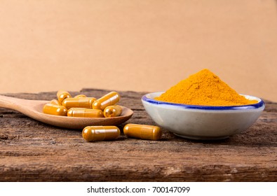 The Turmeric Powder And Capsule And Roots Curcumin On Brown Paper