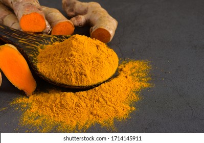 Turmeric Powder And Fresh Turmeric (curcumin) On Black Background,Used For Cooking And As Herbal Medicine,copy Space.