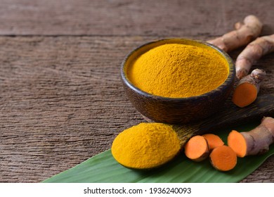 Turmeric Powder And Fresh Turmeric (curcumin) On Wooden Background,Used For Cooking,Natural Fabric Dye,copy Space.