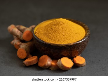 Turmeric Powder And Fresh Turmeric (curcumin) On A Black Background, Spices, Herbal Medicine