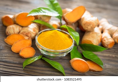 Turmeric powder and turmeric roots on the wooden table
