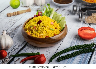 Turmeric rice in a white plate with spices on a white wooden floor - Powered by Shutterstock