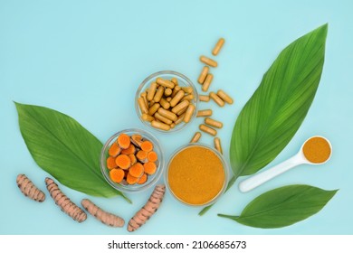 Turmeric root herb with powder, dietary supplement capsules, leaves. Used in alternative natural herbal plant medicine to treat various ailments, anti inflammatory and antioxidant. On blue background.
