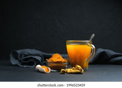 Turmeric tea with spices on a dark background with copy space. - Shutterstock ID 1996523459