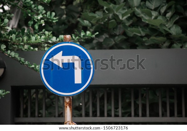 Turn\
left sign board at the garden in Bangkok\
Thailand