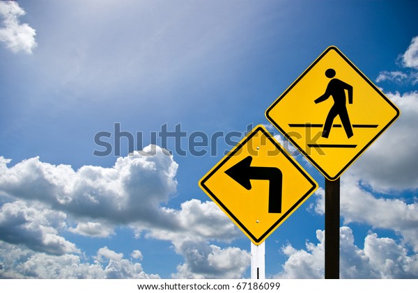 Turn\
left sign and a man walking sign with cloudy\
sky