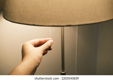 Turn off the floor lamp. Turn off the light by a woman's hand