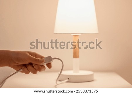 Turn off Light. Switch off the Light. Saving Energy by Turning off the Lights of Table Lamp.