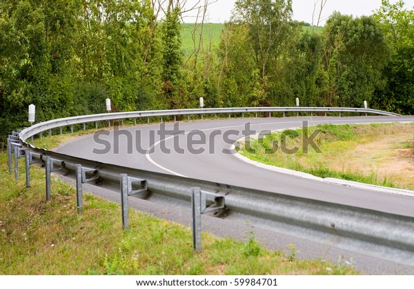 Turn in the road with guard\
rail