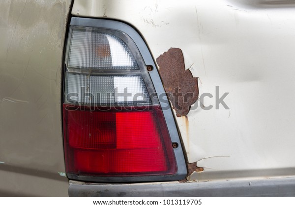 Turn signal, brake lights, back light and rust on\
the car body.