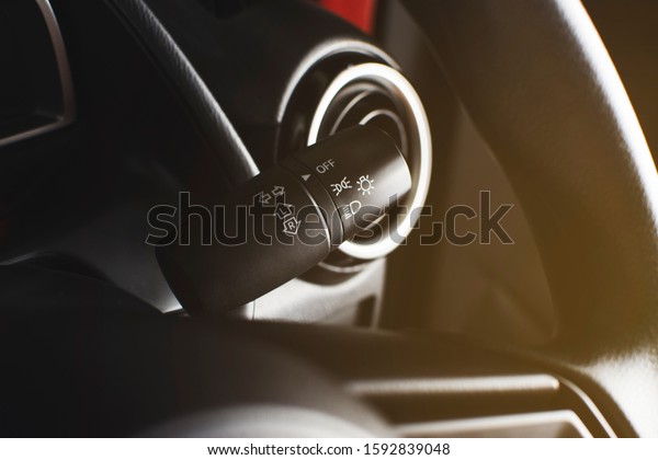 Turn signal\
switch and on-off switch of headlight on a beside of steering\
wheel, automotive part\
concept.