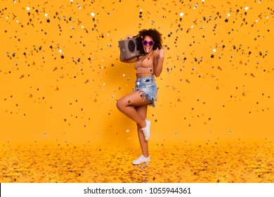 Turn The Volume Up! Full-length Of Cool Crazy Brash Restless Sleepless Swag Noisy  Woman Wearing Star Glasses Knitted Top, Holding Stereo Record Player On Shoulder, Isolated On Yellow Background