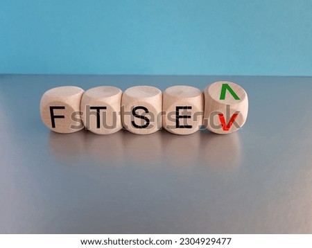 Turned a cube and changes the direction of an arrow symbolizing that the FTSE 100 Index is changing the trend and goes up instead of down. Symbol for the FTSE 100 Index. 