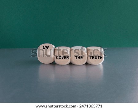 Turned a cube and changes the expression cover the truth to uncover the truth. Beautiful grey table green background. Copy space.