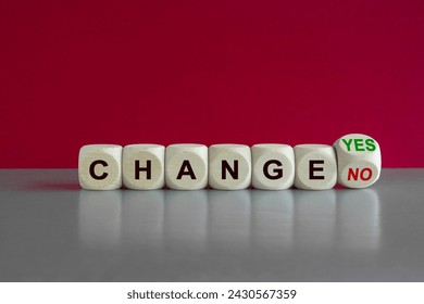 Turned a cube and changes the green words change no to change yes. Beautiful grey table, pink background. Copy space.