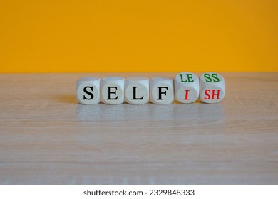 Turned cubes and changes the word 'selfish' to 'selfless'. Beautiful orange background, copy space. Business, psuchological and selfish or selfless concept.