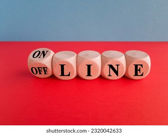 Turned a dice and changes the word OFF LINE to ON LINE. Beautiful blue background, red table, copy space.
