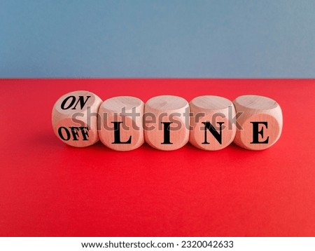 Turned a dice and changes the word OFF LINE to ON LINE. Beautiful blue background, red table, copy space.