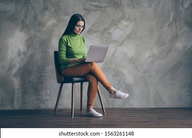 Turned Full Length Body Size Photo Of Woman Developing Strategy For Startup In Orange Pants White Footwear Near Empty Space On Laptop Isolated Wall Concrete Grey Color Background