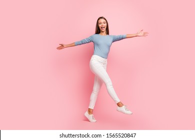 Turned full length body size of cheerful cute nice pretty sweet girl spreading her arms to sides to invite you to be embraced stepping isolated pastel color background in blue sweater