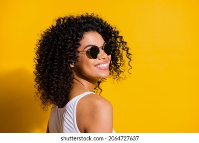 Turned photo of charming afro american woman happy smile wear white tank-top isolated on vibrant yellow color background