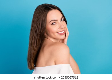 Turned photo of happy young positive woman touch face good mood smile isolated on blue color background