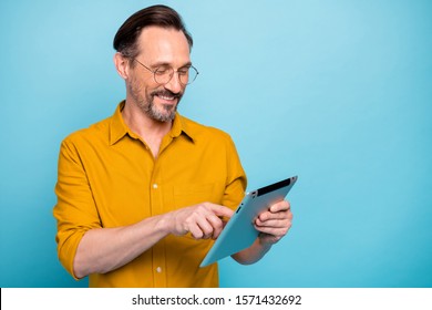 Turned Photo Of Positive Cool Man Tablet User Search Social Media Information Feel Dreamy Glad Expression Wear Stylish Clothing Isolated Over Blue Color Background